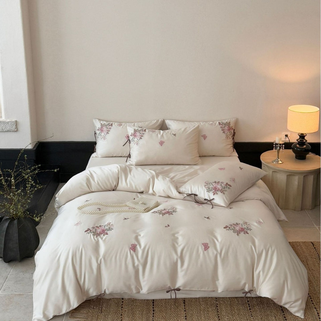 Silky-matte satin bedding set with embroidered rose bouquets and ties