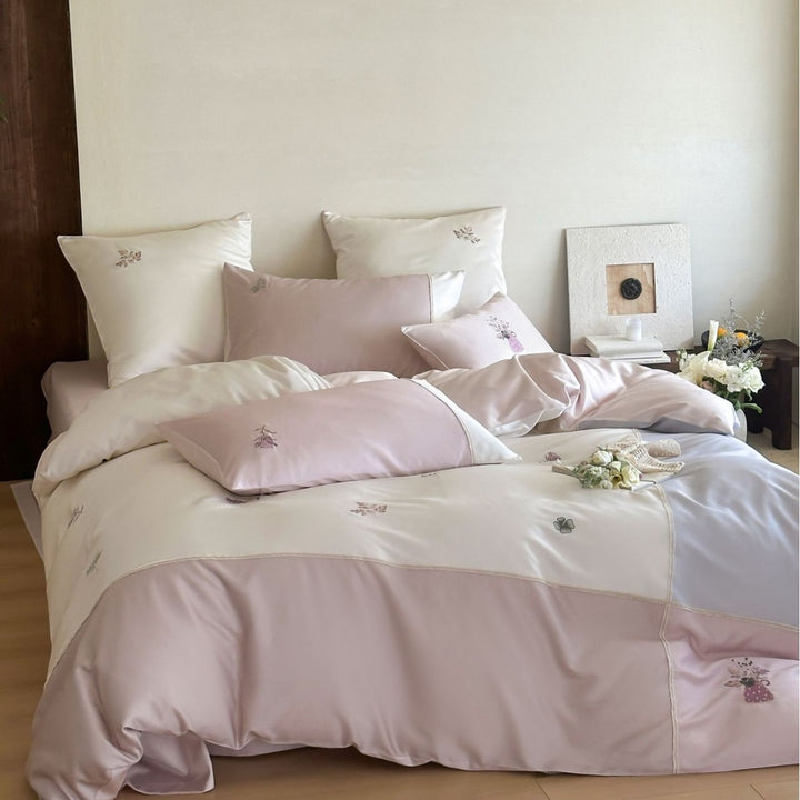 Satin bedding set with delicate floral embroidery and noble piping