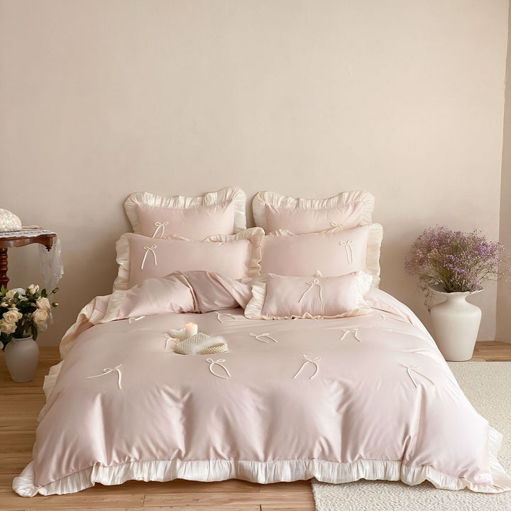 Satin bedding set with ruffle edges, delicate bow appliqué and pillowcases