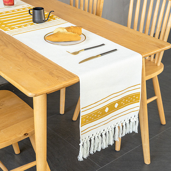 Woven Boho table runner made of cotton blend with decorative fringes and graphic stripe pattern Bowlift