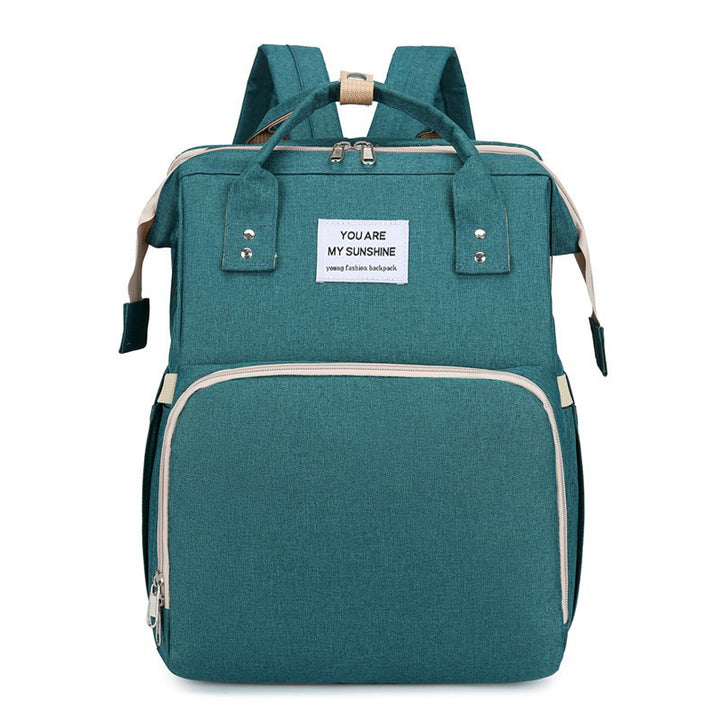 Diaper backpack with integrated changing bed
