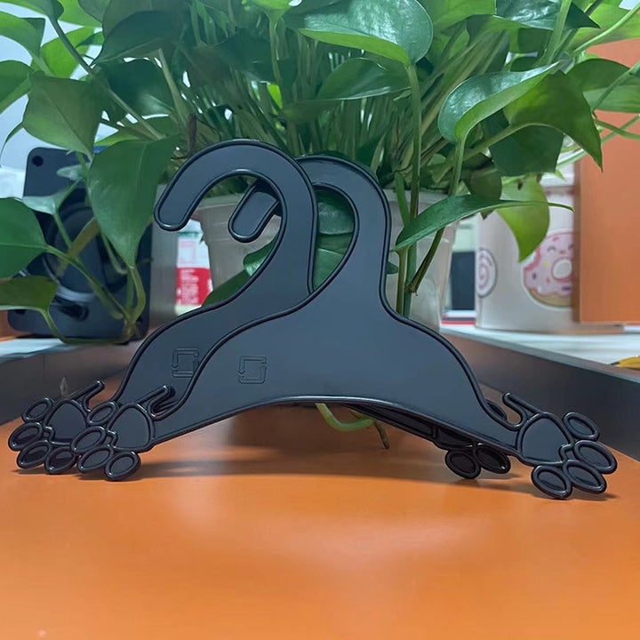 Plastic clothing hanger in dog paw shape