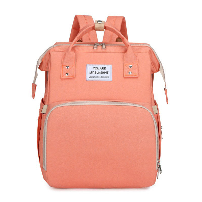 Diaper backpack with integrated changing bed