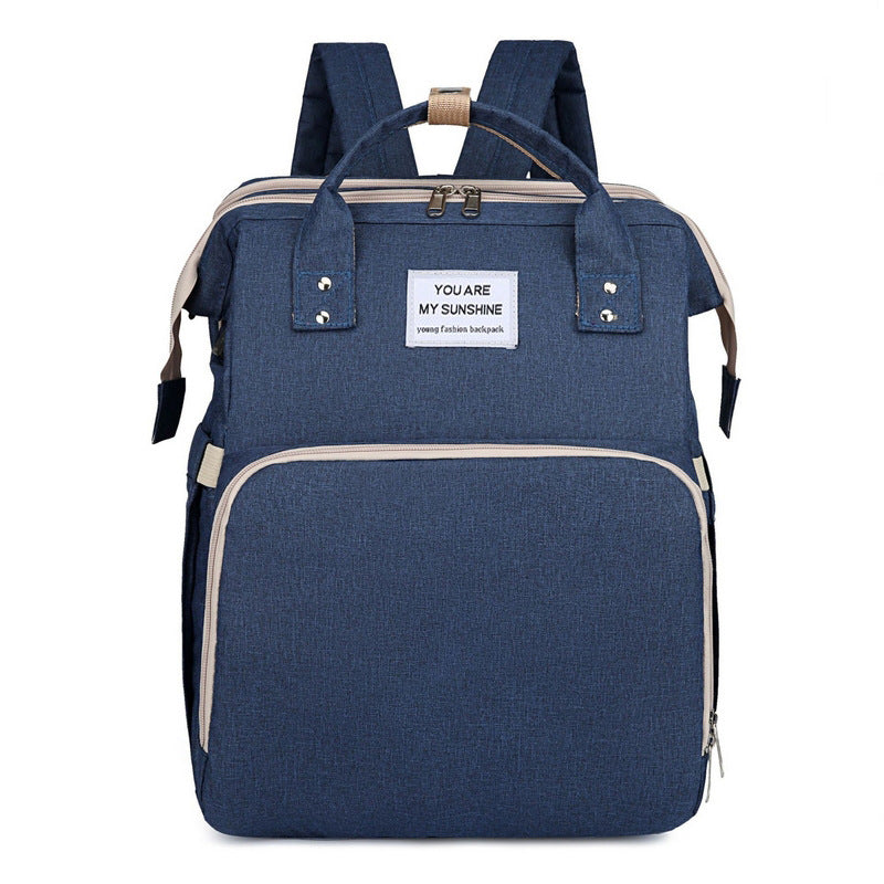 Diaper backpack with integrated changing bed