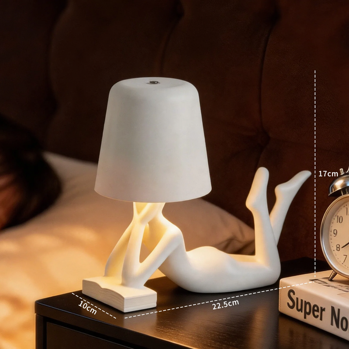 Modern table lamp with reclining figure shape