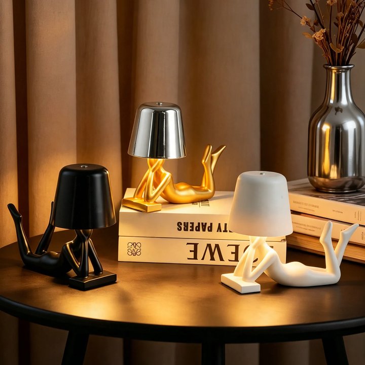 Modern table lamp with reclining figure shape