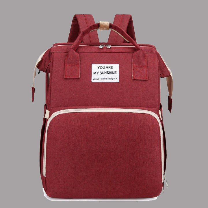 Diaper backpack with integrated changing bed