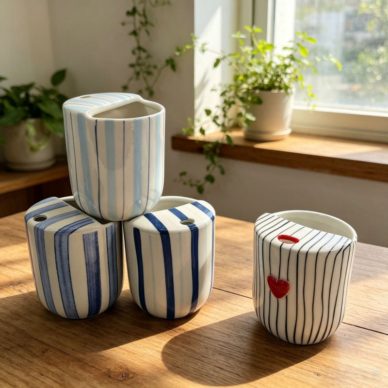 Ceramic coffee mug with stripes and heart design