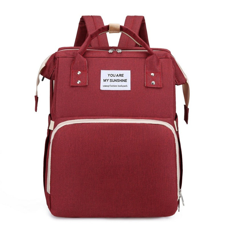 Diaper backpack with integrated changing bed