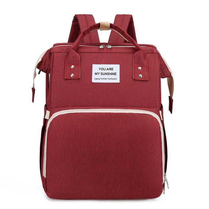 Diaper backpack with integrated changing bed