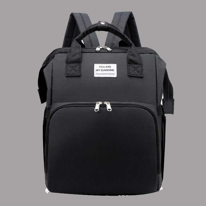 Diaper backpack with integrated changing bed